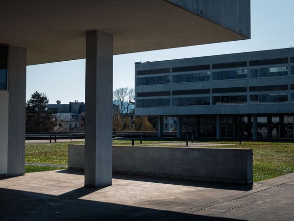 University buildings around an open green campus lawn.